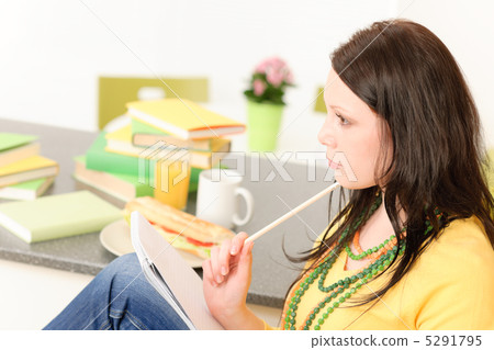 Young student girl thinking in kitchen Young student girl thinking in kitchen 5291795