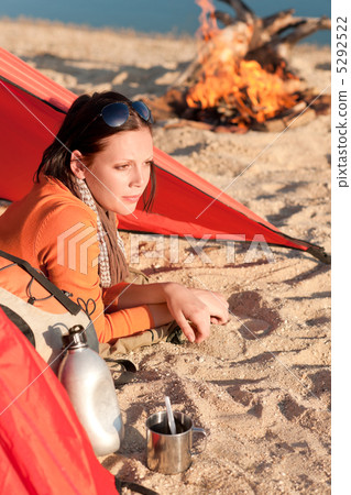 Camping happy woman relax in tent by campfire 5292522