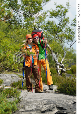 Hiking young couple point at panoramic view Hiking young couple point at panoramic view 5292563