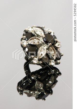 Ring with flower ornament on reflective background 5294582