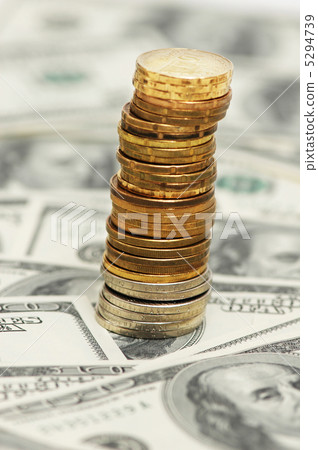 Stack of coins on the dollar background Stack of coins on the dollar background 5294739