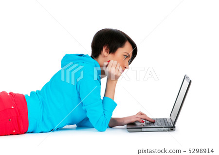 Young girl working on laptop isolated on white Young girl working on laptop isolated on white 5298914