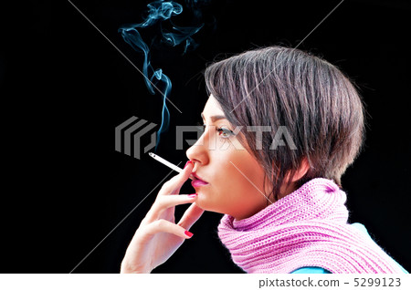 Young girl smoking on black 5299123