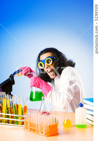 Chemist in the lab experimenting with solutions 5299509