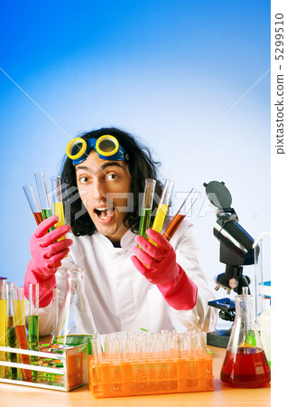Chemist in the lab experimenting with solutions 5299510