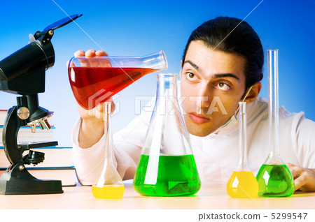 Chemist in the lab experimenting with solutions 5299547