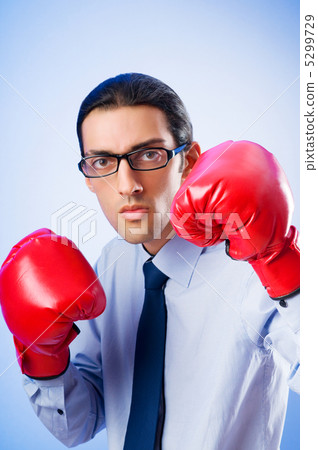 Businessman with boxing gloves Businessman with boxing gloves 5299729