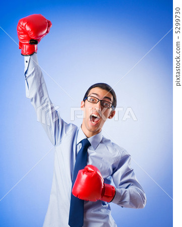 Businessman with boxing gloves Businessman with boxing gloves 5299730