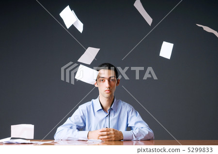 Flying paper and businessman in office 5299833