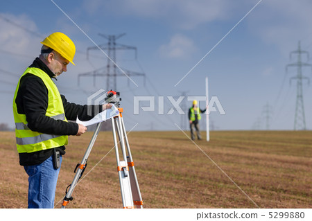 Geodesist measure land on construction site Geodesist measure land on construction site 5299880