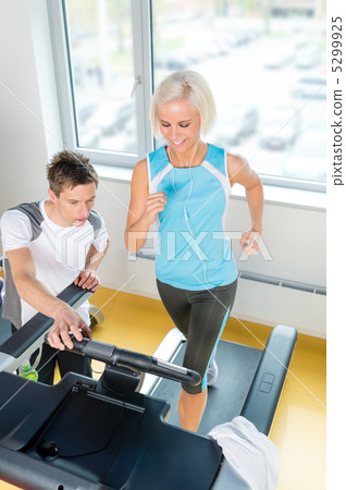 Young fitness instructor woman running at gym 5299925