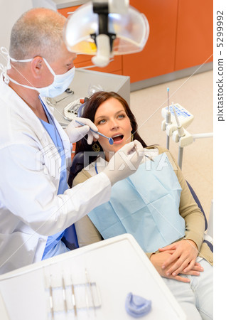 Dentist checkup procedure female patient on chair 5299992