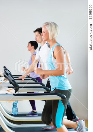 Running on treadmill young people fitness center Running on treadmill young people fitness center 5299993
