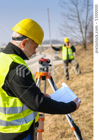 Geodesist read plans on construction site Geodesist read plans on construction site 5300000