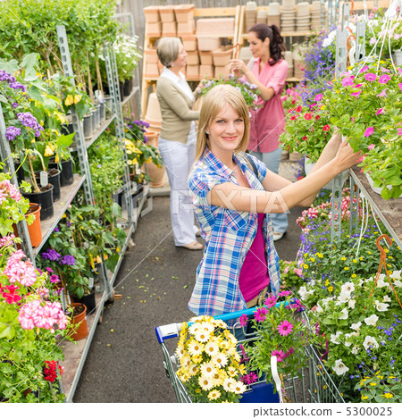 Woman shopping for flowers in garden shop 5300025