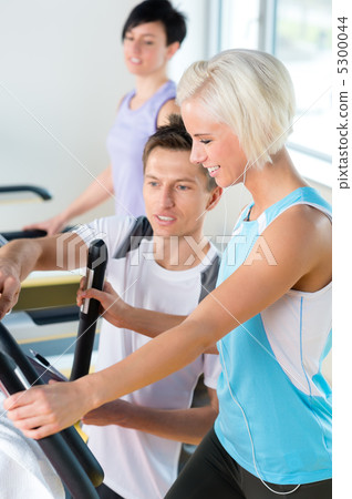 Fitness young people on treadmill cardio workout Fitness young people on treadmill cardio workout 5300044