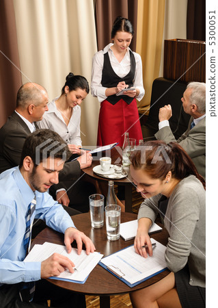 Waitress take order businesspeople conference room 5300051