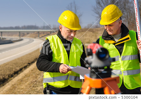 Geodesist two man theodolite stand highway Geodesist two man theodolite stand highway 5300104