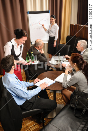 Waitress serving business people conference room 5300137