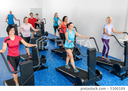 Fitness class walking on treadmill running belt Fitness class walking on treadmill running belt 5300189