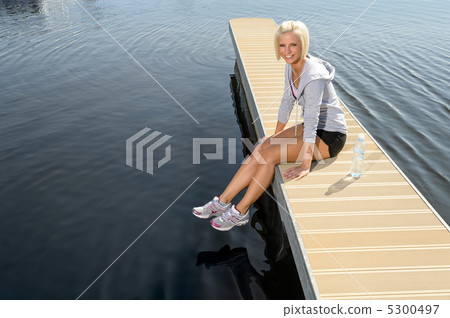 Young sport woman relax on pier water Young sport woman relax on pier water 5300497