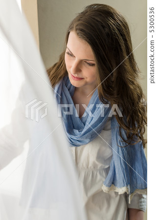 Brunette young woman looking down window Brunette young woman looking down window 5300536