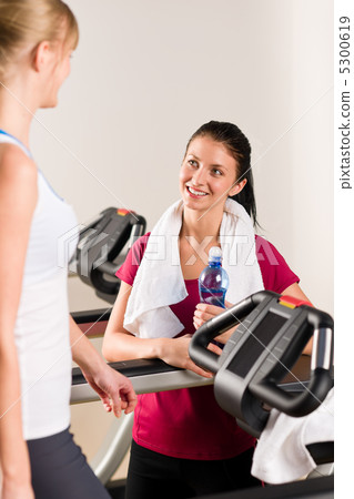 Young female friends chatting in fitness center Young female friends chatting in fitness center 5300619
