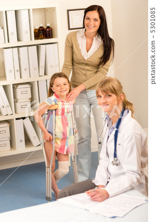 At the pediatrician little girl with crutches 5301085