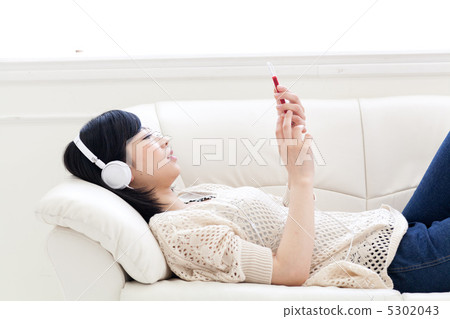A woman listening to music A woman listening to music 5302043