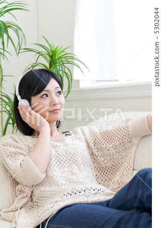 A woman listening to music A woman listening to music 5302044