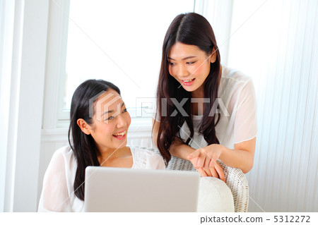 Two women sitting in a chair Two women sitting in a chair 5312272