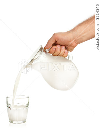 Hand pouring milk from jug to glass Hand pouring milk from jug to glass 5314546