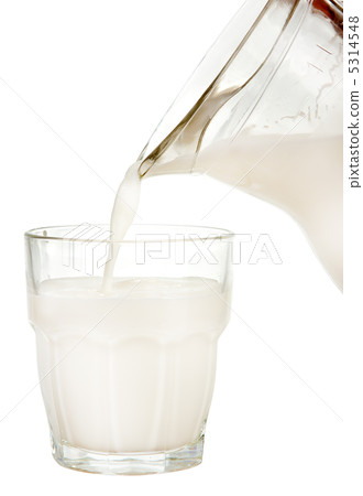 Jug of milk poured into glass Jug of milk poured into glass 5314548