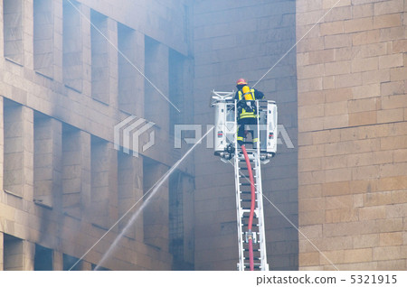 Firefighter at the fire in the city center Firefighter at the fire in the city center 5321915