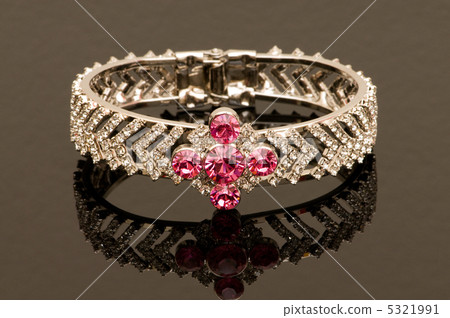 Bracelet with red stones on reflective background 5321991