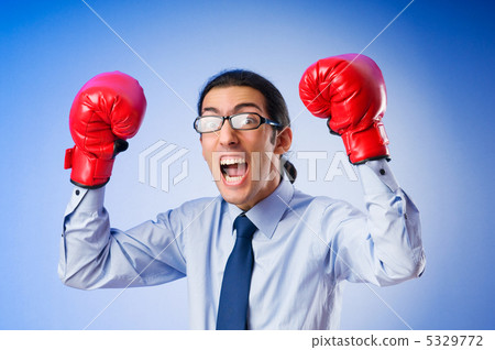 Businessman with boxing gloves Businessman with boxing gloves 5329772