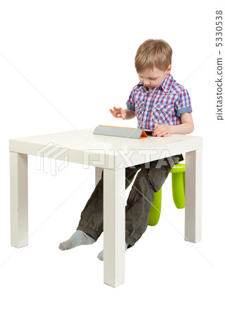 boy with a Tablet PC on the desk boy with a Tablet PC on the desk 5330538