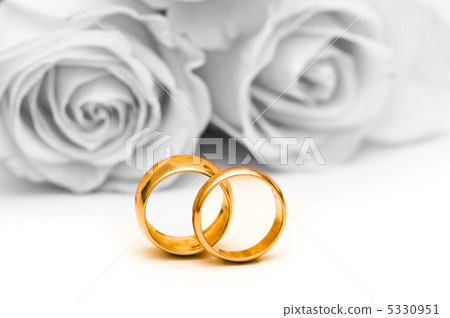 Roses and wedding ring isolated on the white 5330951