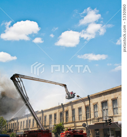Boom of a firetruck during fire in the city Boom of a firetruck during fire in the city 5330960