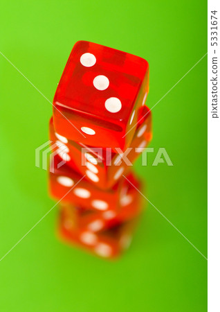 Red dice against green background - shallow DOF Red dice against green background - shallow DOF 5331674