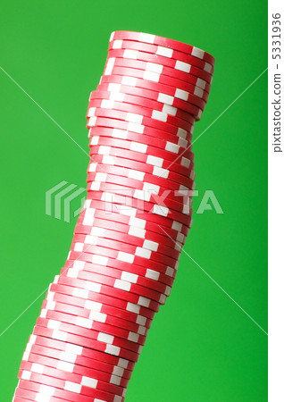 Stack of red casino chips against green background 5331936