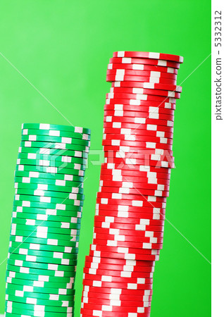 Stack of red and green casino chips against green background Stack of red and green casino chips against green background 5332312