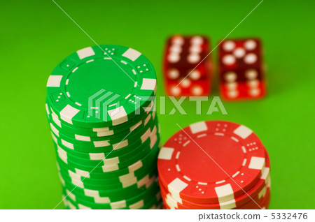 Casino chips and dice against green background Casino chips and dice against green background 5332476
