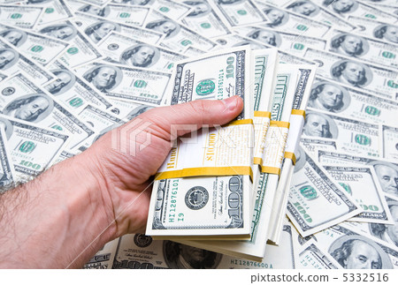 Hand holding american dollars against money background Hand holding american dollars against money background 5332516