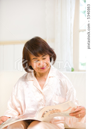 Senior woman reading catalog 5340863
