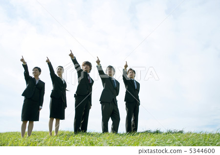 A businessman and a business woman pointing his finger in the meadow 5344600