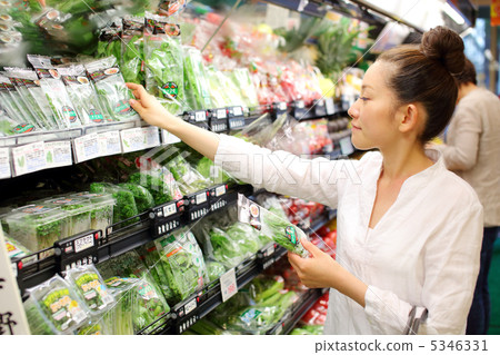A woman shopping at a supermarket 5346331
