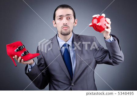 Man with piggybank on grey Man with piggybank on grey 5348495