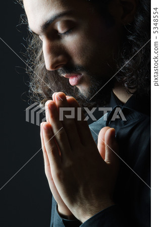 Young man praying in darkness 5348554