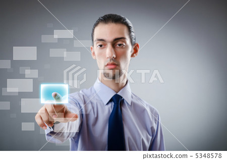 Businessman pressing virtual buttons Businessman pressing virtual buttons 5348578